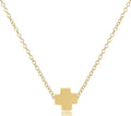 Gold cross necklace on a white background