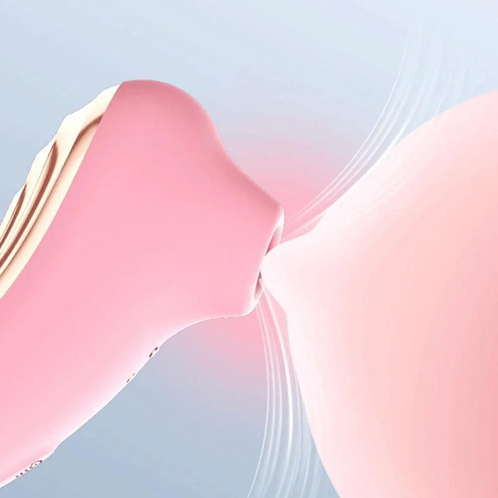 Pink 2-in-1 suction stimulator for women, close-up showing soft silicone tip in use.
