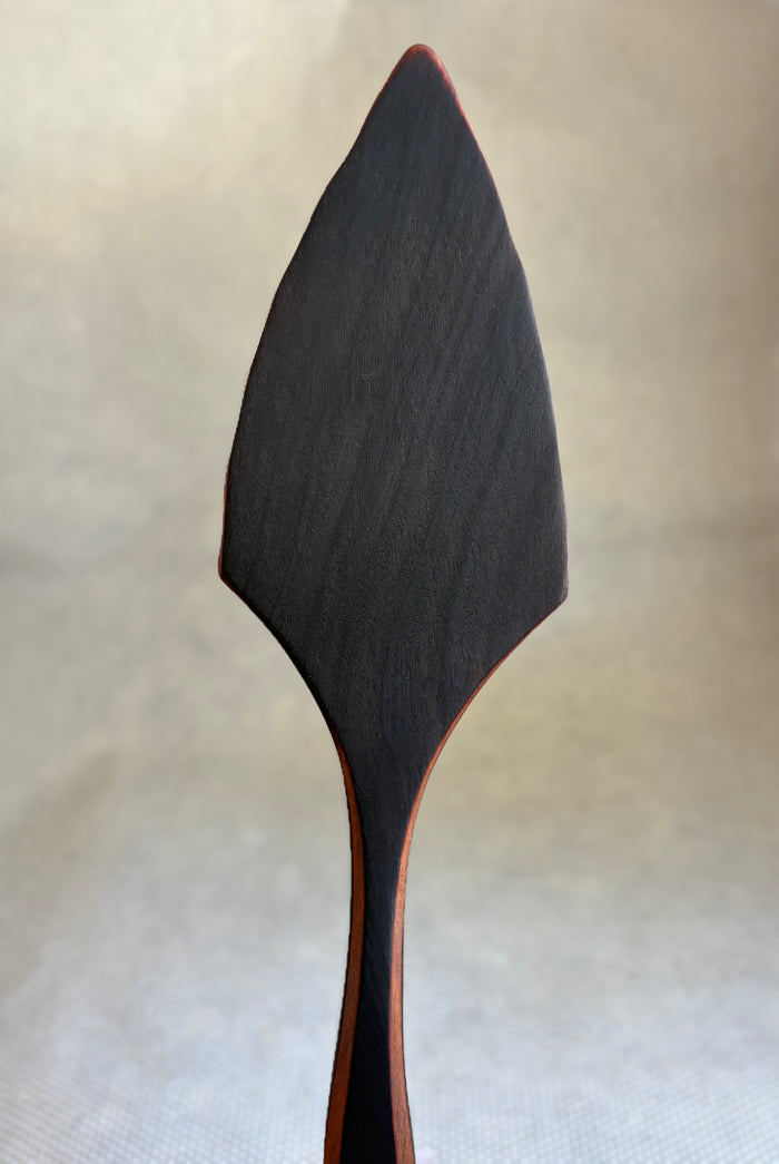 Jonathan's Spoons blackened natural wooden pie server on light natural background.