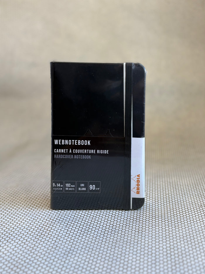 Black notebook with white text on a textured surface