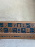 Uncle Goose perpetual calendar with blue text and symbols on a cardboard box.