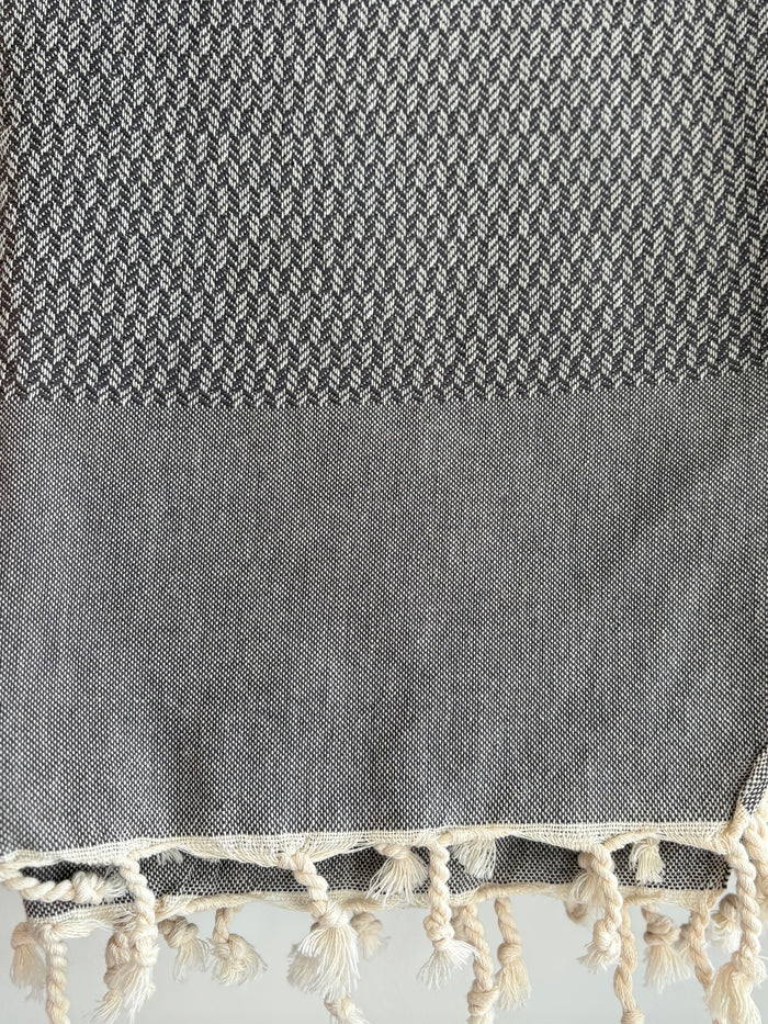 dark grey tweed weave towel.