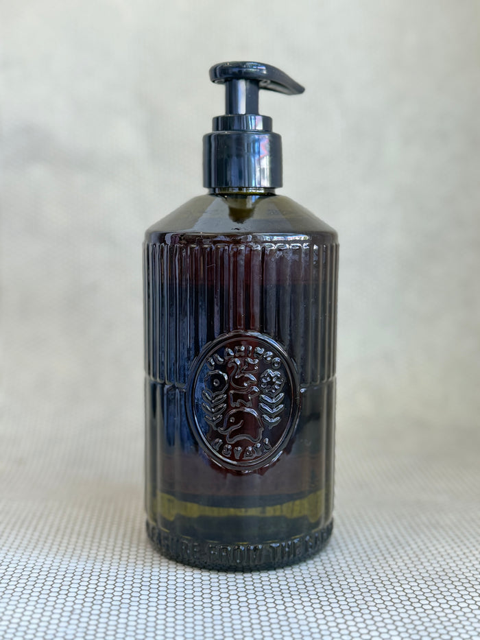 dark green glass pump bottle of flamingo estate hand soap jasmine damask rose