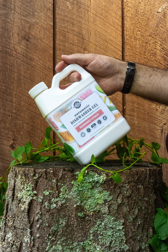 Rustic Strength, Person holding a 32 oz Automatic Dishwasher Gel