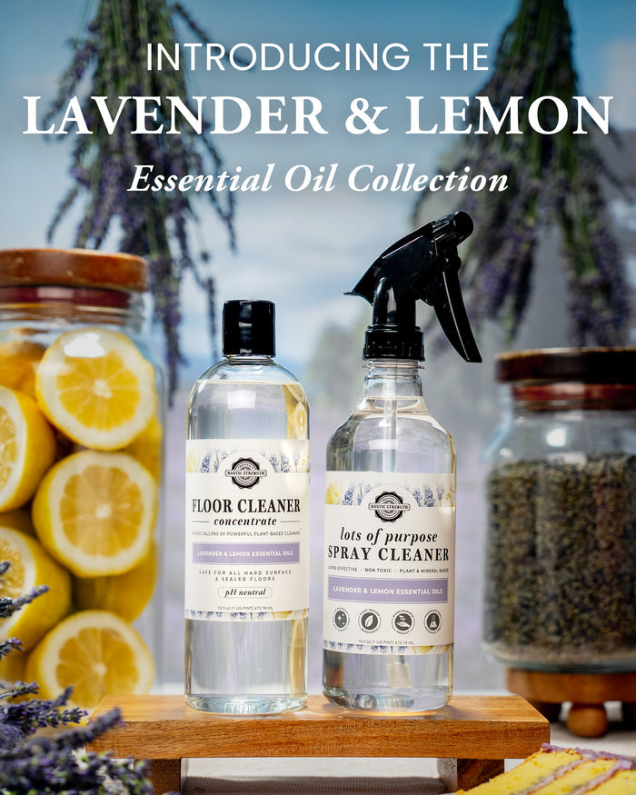 Rustic Strength - Photoshoot image: 16 oz each Lavender & Lemon Floor Cleaner Concentrate and Lots of Purpose Spray Cleaner on a wooden surface with lavender and lemon slices in the background.