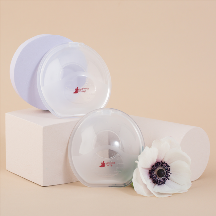 MammaBump breast milk collectors in pair to catch natural letdown while breastfeeding, shown with packaging