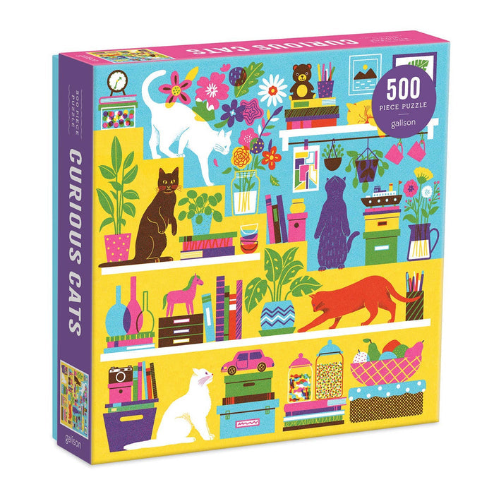 A colorful 500 piece puzzle box featuring various playful illustrations of cats, books, and household items.