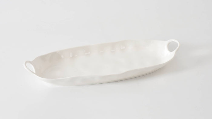 White ceramic platter on a light gray background