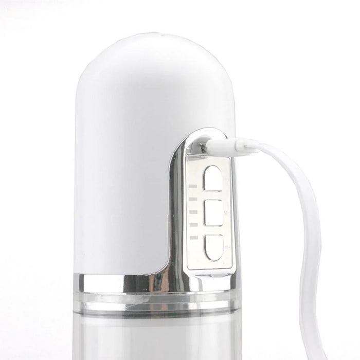 Close-up of white automatic vacuum pump device with control buttons and charging cable