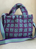 Epice blue and purple handbag with handler and strap.