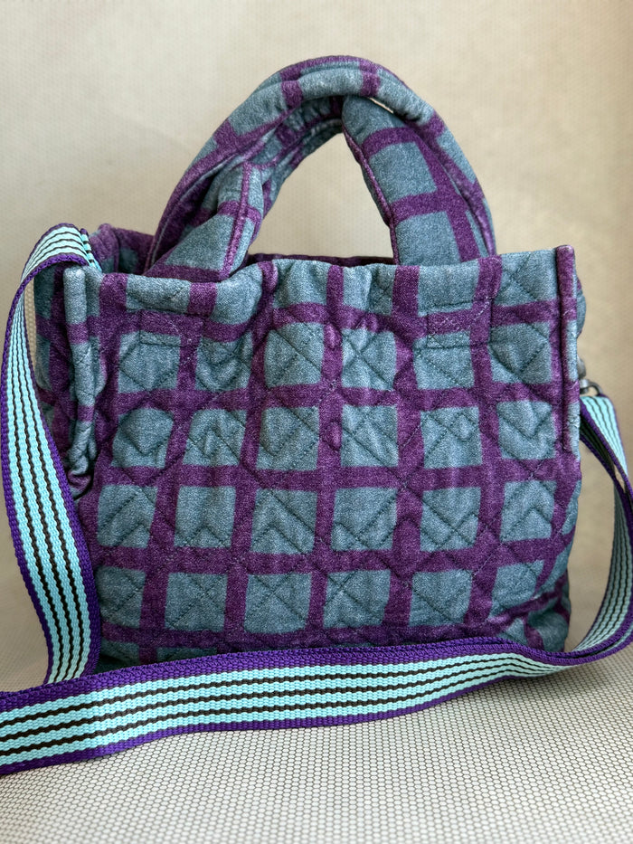 Epice blue and purple handbag with handler and strap.