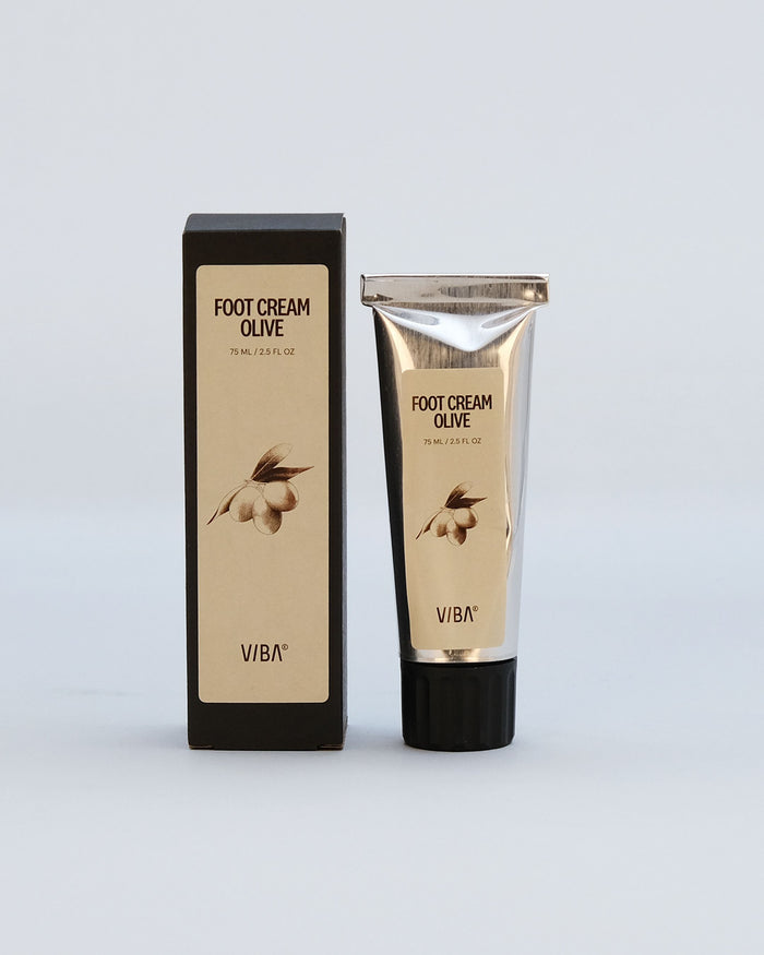 Olive foot cream in a 75ml tube next to its black and beige box with olive branch illustration.
