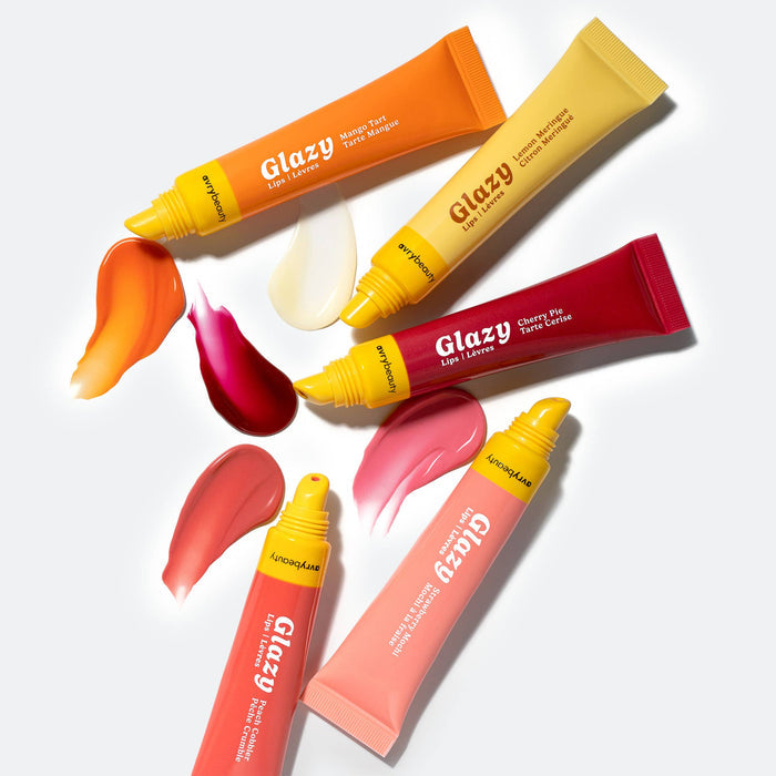 Glazy lip products with colorful tubes and swatches on a white background