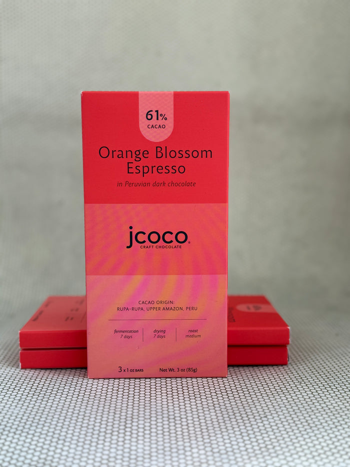red dark chocolate bar packaging with jcoco branding on neutral background.