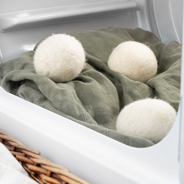 Rustic Strength - Jumbo Wool Dryer Balls ( 3 pack ) resting on a blanket in the dryer