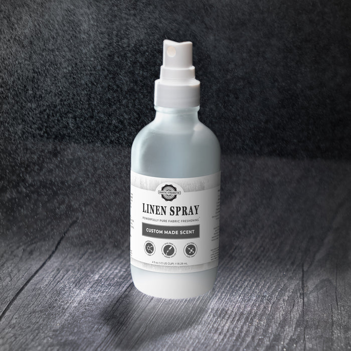 Rustic Strength - Linen Spray with a dark background shown with mist surrounding