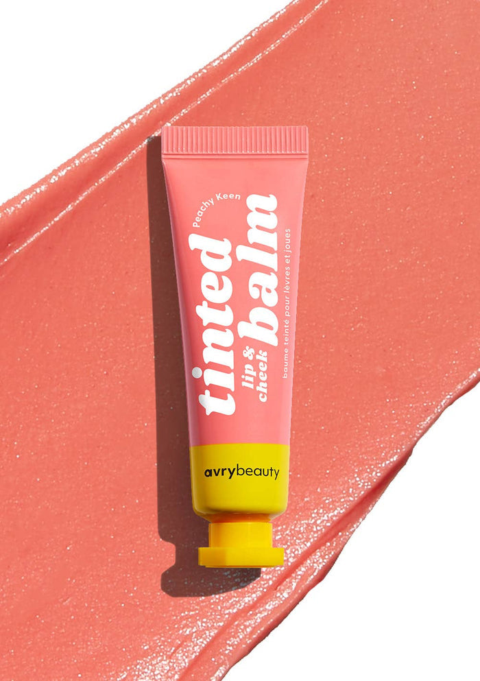 Avry Beauty tinted lip and cheek balm tube on a pink background