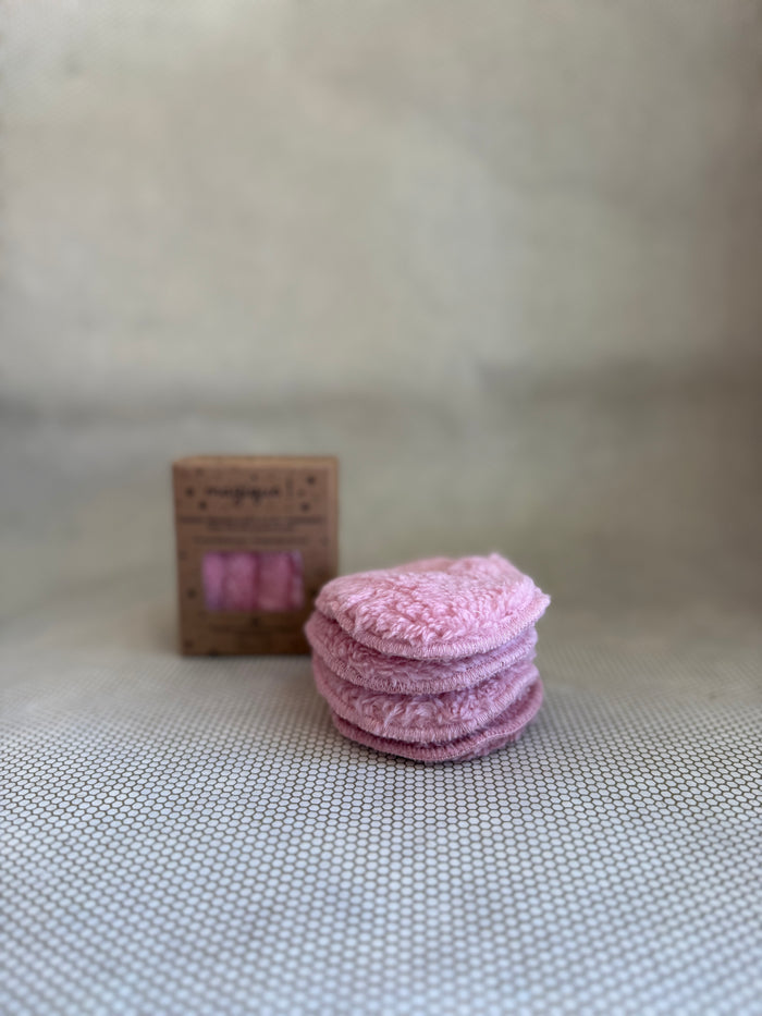 stack of Malou et Marius pink fluffy eye makeup remover pads and cardboard packaging in background.