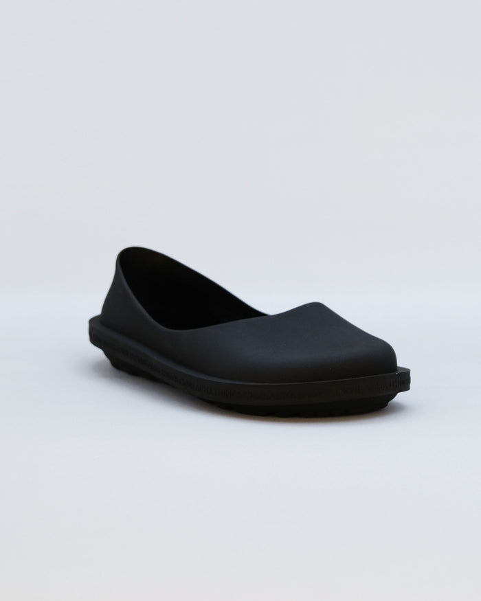 Black rubber clog with curved upper and chunky platform sole, shown from side angle.