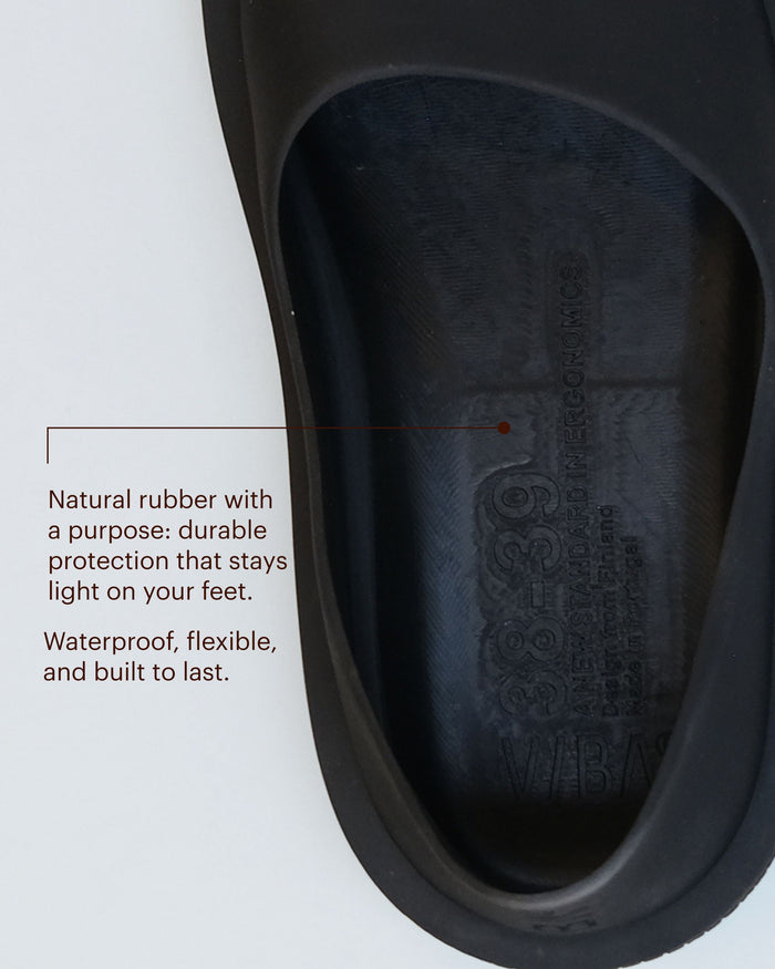 Black rubber shoe sole with embossed brand logo and tread pattern.