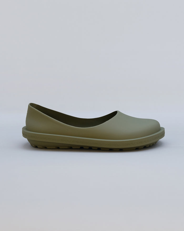 Moss-colored natural rubber slip-on shoe with textured sole and curved upper, shown in profile view.