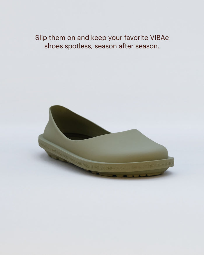 Sage green rubber clog with textured sole and curved heel cutout.