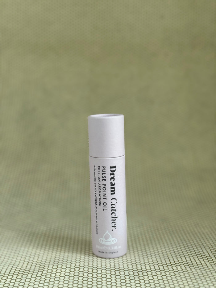 Osmology Dream Catcher pulse point roll-on aromatherapy oil in baby pink packaging.