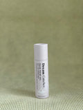 Osmology Dream Catcher pulse point roll-on aromatherapy oil in baby pink packaging.