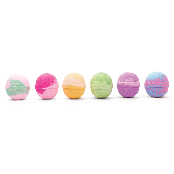 an assortment of multicolored bath bombs lined up against a white background