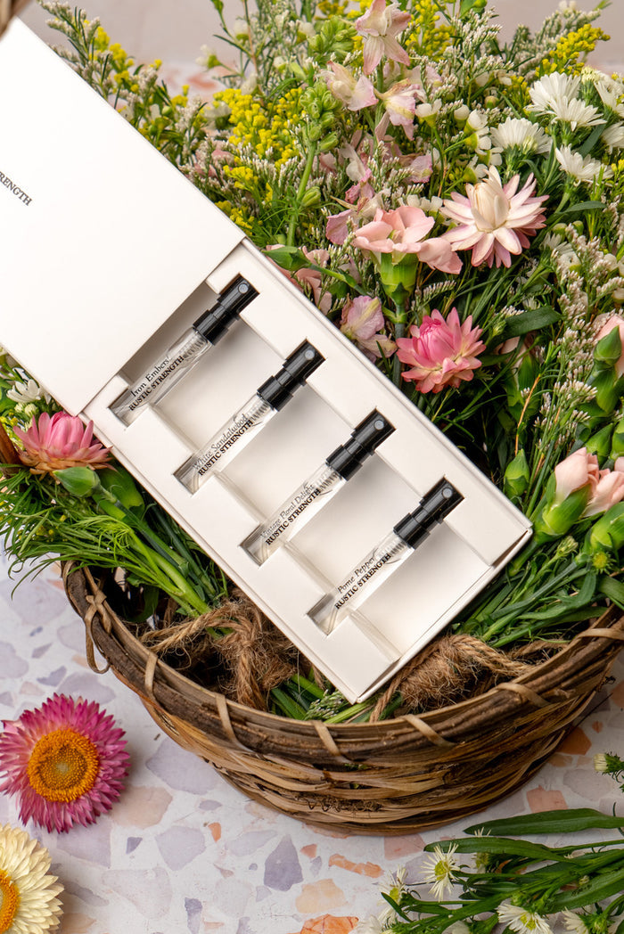 Perfume collection sample pack- Iron Embers, Pome Pepper, Vintage Floral Delight, and White Sandalwood in basket of flowers