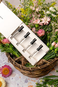 Perfume collection sample pack- Iron Embers, Pome Pepper, Vintage Floral Delight, and White Sandalwood in basket of flowers