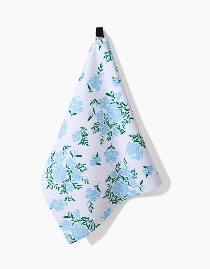 Floral patterned towel hanging on a white background