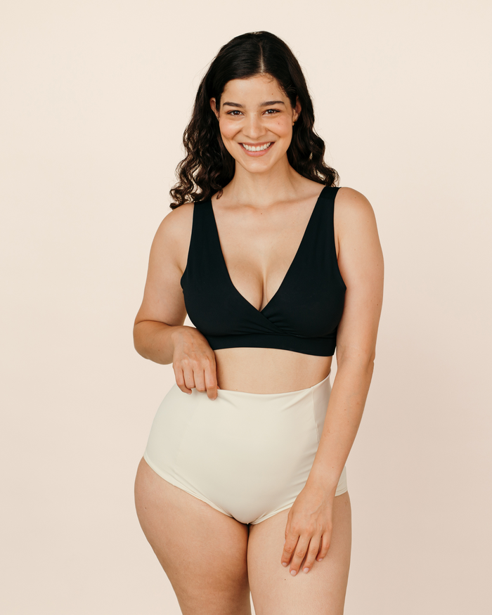 Smiling new mum wearing cream MammaBump Postpartum Soothing Briefs, high-waisted and seamless for comfortable postpartum recovery
