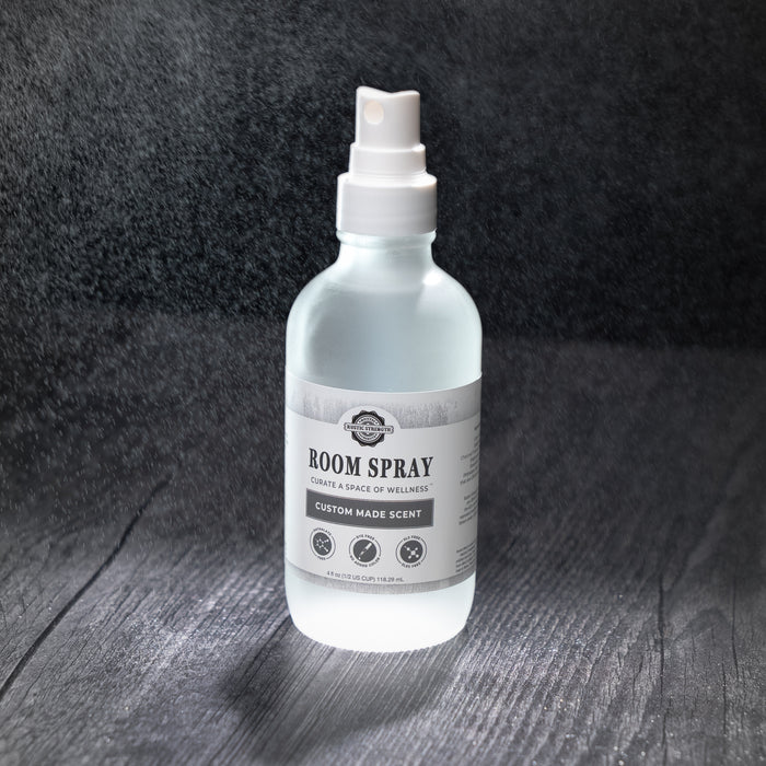 Rustic Strength, Room Spray, 4oz setting on a dark background with spray surrounding as scent dispurses