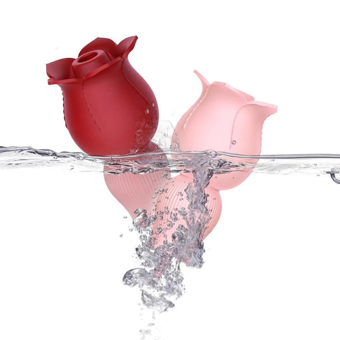 Waterproof rose-shaped silicone personal massagers in red and pink submerged in water