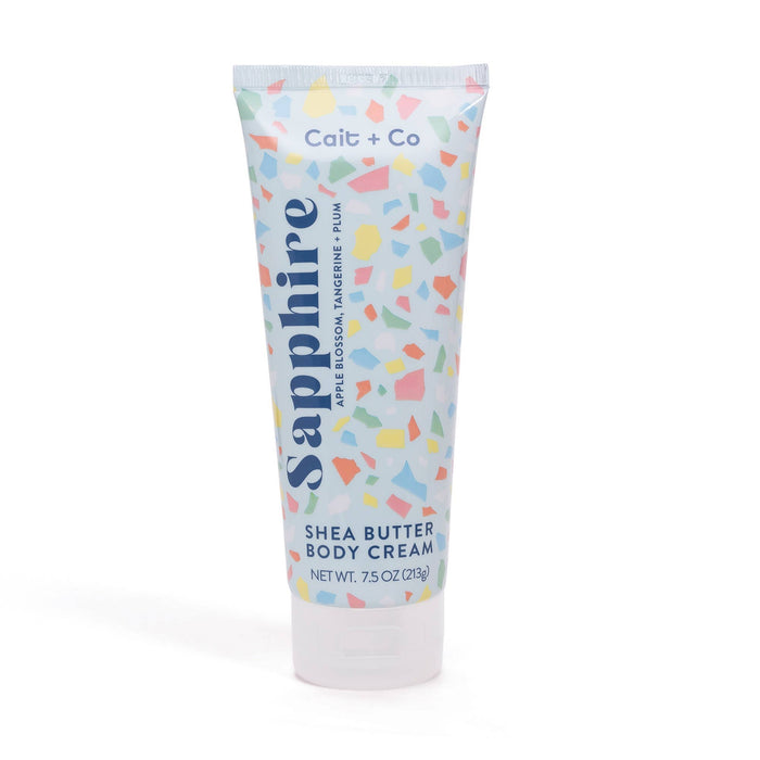Tube of Cait + Co Shea Butter Body Cream with colorful gem-inspired design on the packaging