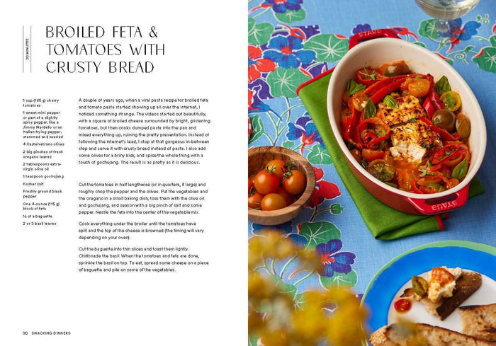 Recipe for broiled feta and tomatoes with crusty bread on a colorful tablecloth.