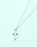 Necklace with a pink cross pendant on a light blue background