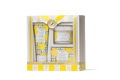 Beekman 1802 skincare set with yellow accents in a decorative box on a white background