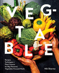 A book cover of 'Veg-table' featuring a bunch of various vegetables arranged in a wheelbarrow, with the title prominently displayed.