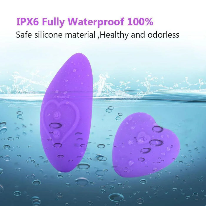 Purple waterproof silicone wearable stimulator devices submerged in water, heart-shaped accent